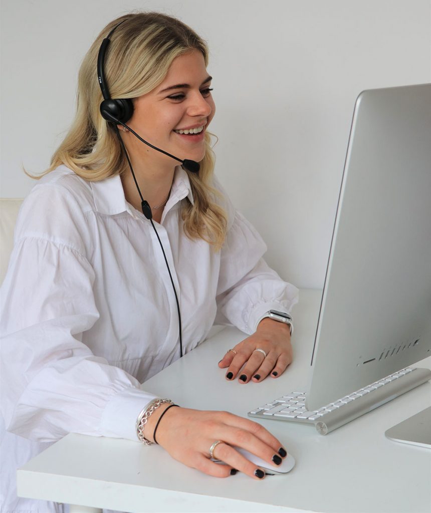Woman with computer talking into a headset